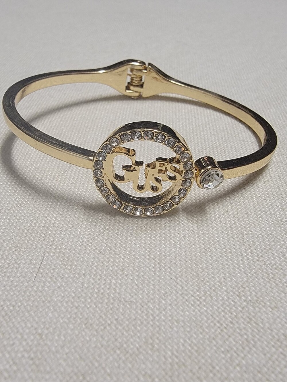 Guess Gold Tone Hinge Bangle Rhinestone Logo Bracelet
